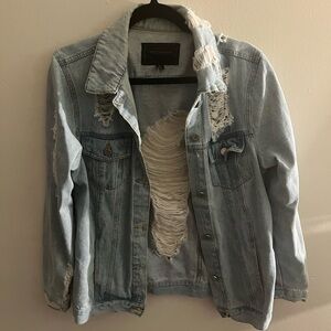 A Miss London, light blue denim jacket with ripped design. Size medium.
